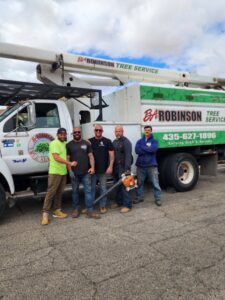 The BA Robinson Tree Service team standing proudly in front of their branded bucket truck in Saint George, UT.