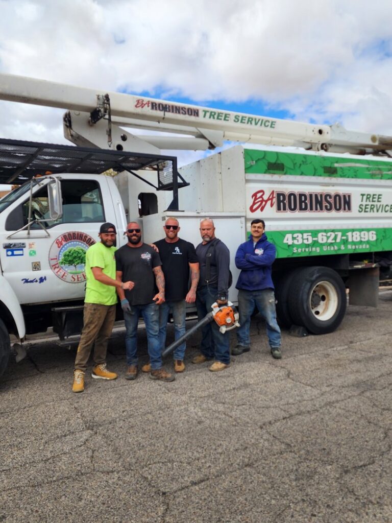 The BA Robinson Tree Service team standing proudly in front of their branded bucket truck in Saint George, UT.