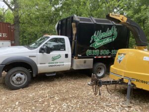 An Affordable Treefellers truck with a large wood chipper attached, ready for tree service work in Shawnee, KS.