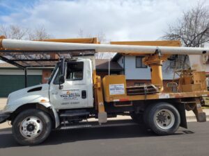 A tree service truck with a boom lift from Northern Colorado Tree Service in Fort Collins, CO.