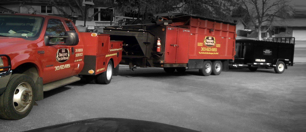 A red tree service truck with specialized equipment for AAA Emergency Tree Service LLC in Denver, CO.