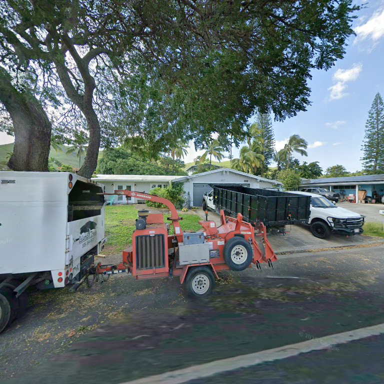 An Island Trees service truck with a wood chipper and dump trailer parked in Bethpage, NY.