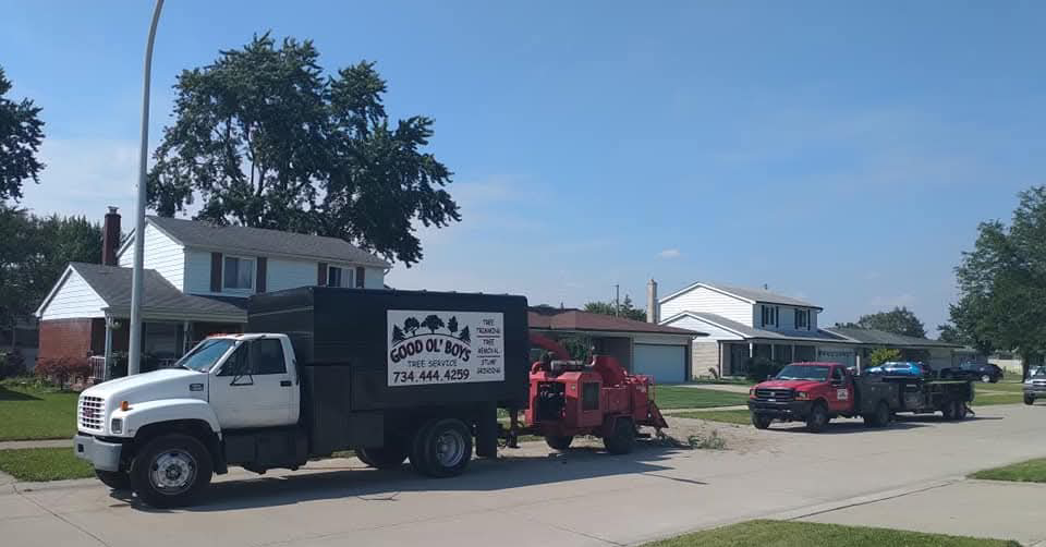 Good Ol' Boys Tree Service trucks and a wood chipper parked on a residential street in Lebanon, CT, ready for a job.