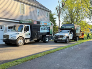 Two Triple A Tree Service PA trucks and a wood chipper ready for tree work in Philadelphia, PA.