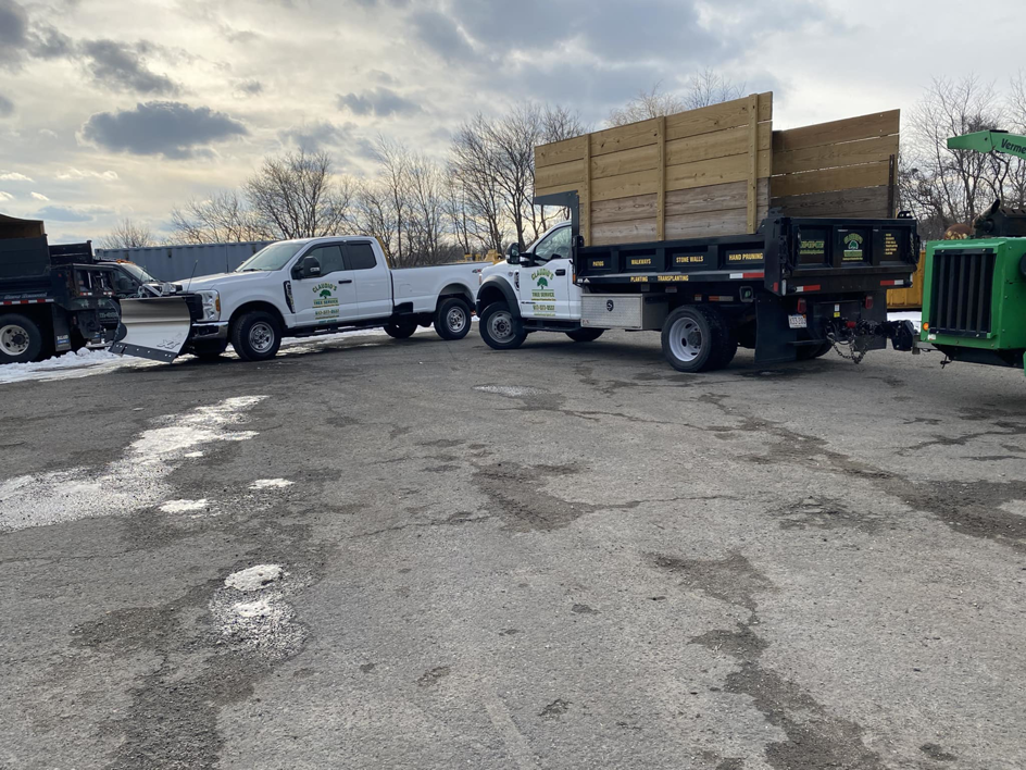 Claudio's Tree Service & Landscape Constructions Corp trucks and a wood chipper parked, ready for tree service jobs in Lynn, MA.