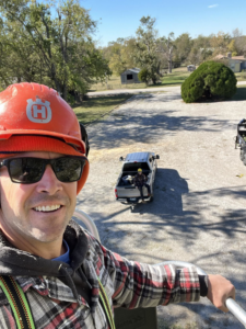 A tree service worker taking a selfie from an elevated position during a job for Hickman Tree Service in Orangeville, PA.