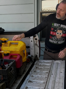 A tree service worker loading equipment and gas cans into a pickup truck for Element Tree Service in Sioux Falls, SD.