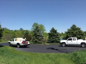 A worker spraying a tree with treatment from a truck, provided by Arborscape Tree Care in Ankeny, IA.