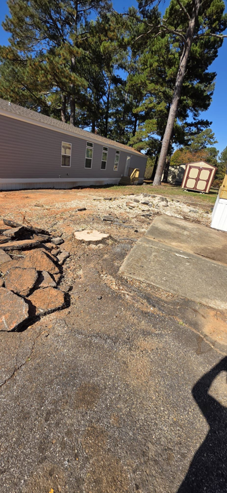 A tree stump and disturbed ground after a professional tree removal service by Treevol Service LLC in Gwinnett, Atlanta, GA.