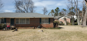 A tree stump remaining in a residential front yard after tree removal by Chris's Tree Service in Hazel Green, AL