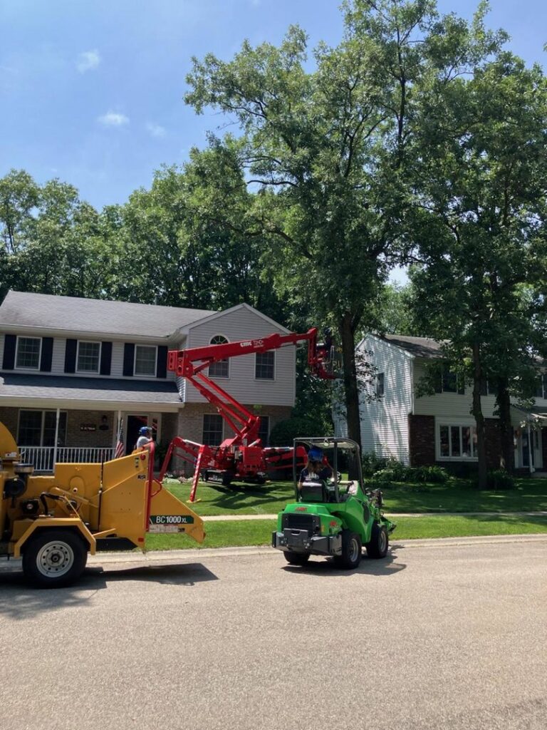 Tree trimming and wood chipping equipment on site for a residential tree service job by SKV Tree Service in Morris, IL.