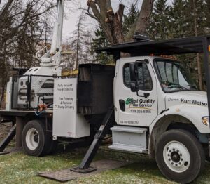 A Best Quality Tree Service bucket truck at a residential job site after trimming a large tree in Oshkosh, WI.