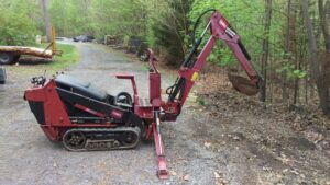 A trenching machine used for digging fence or deck post holes by Quality Fence & Deck Co. in Frederick, MD.