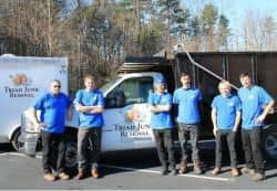 The Triad Junk Removal team standing proudly in front of their service trucks in Greensboro, NC.