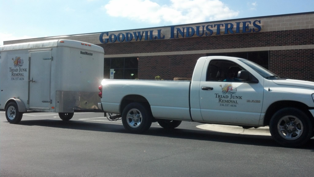 Triad Junk Removal truck and enclosed trailer parked at Goodwill Industries in Greensboro, NC.
