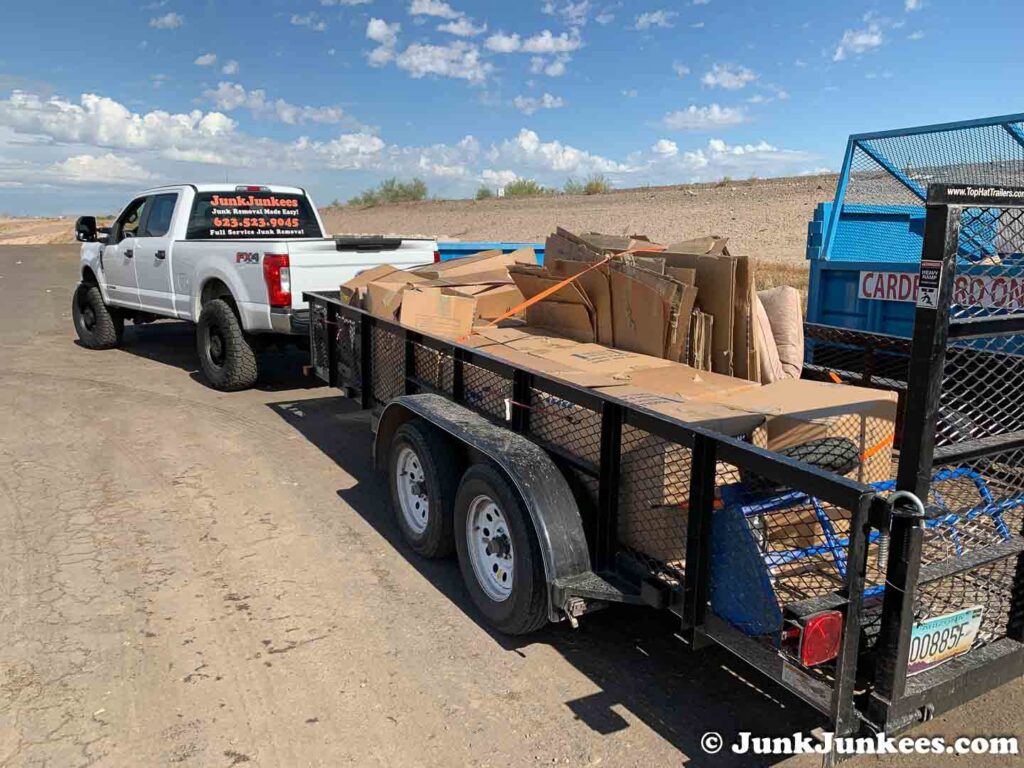 A Junk Junkees truck and trailer hauling a load of flattened cardboard boxes for recycling in Peoria, AZ.