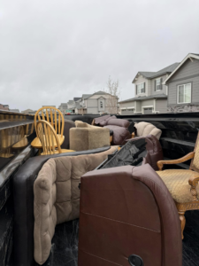 A truck bed filled with various furniture items, ready for hauling by Clean Slate Junk Removal in Denver, CO.