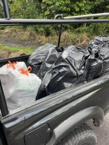 A pickup truck bed filled with various trash bags after a junk removal job by Malama Trash Services LLC in Hilo, HI.