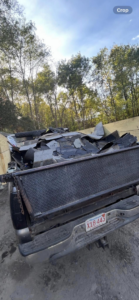 A truck bed filled with old roofing shingles and construction debris, indicating a junk removal service by Trash Hogs in Worcester, MA.