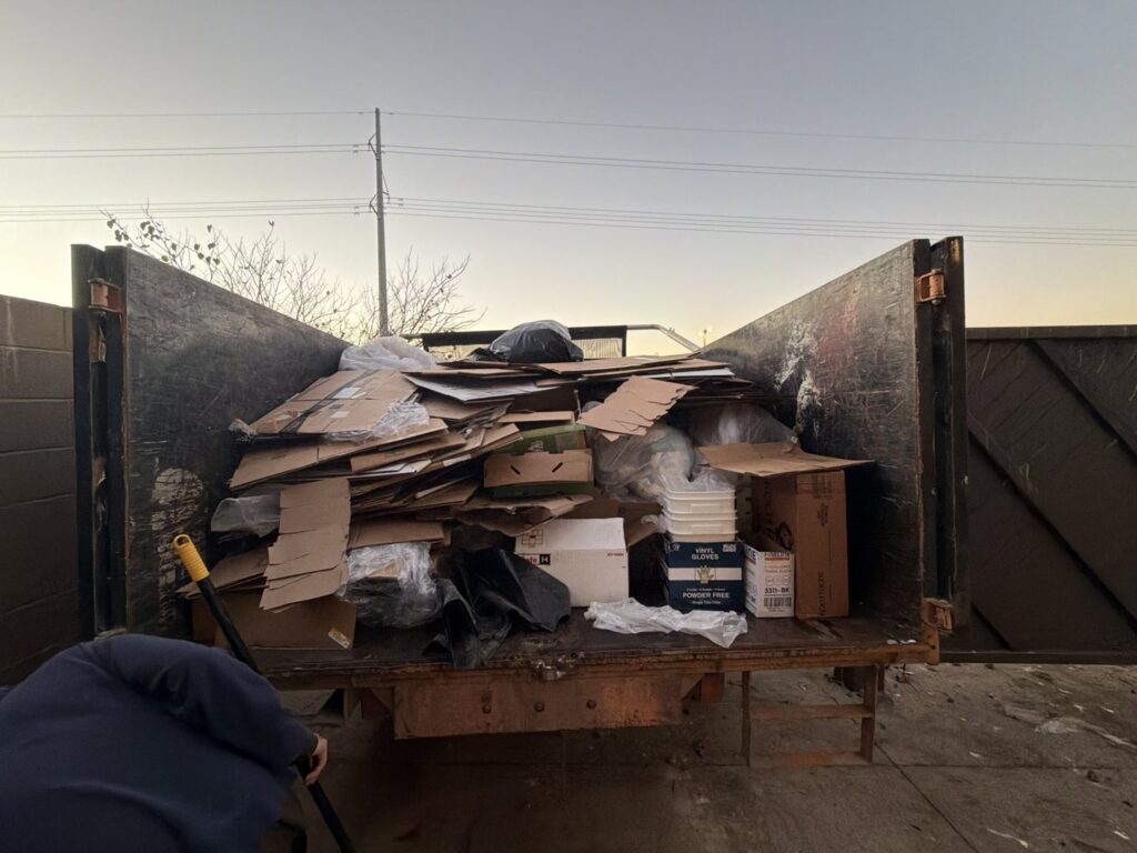 A truck bed filled with cardboard boxes and black trash bags, representing a completed junk removal job by Junk Out Boyz LLC in Georgetown, TX.