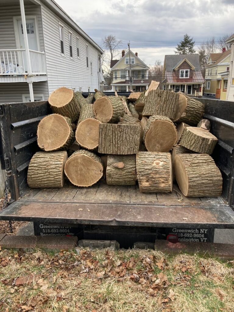 Truck bed filled with freshly cut logs and wood, ready for hauling after tree service by Sky High Tree Service in Lynnwood, WA.