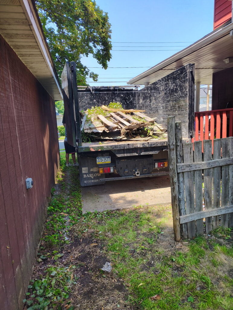 A truck bed filled with wood and other debris, indicating a junk removal job in progress by Junken Monkeys Hauling Company in Scranton, PA.