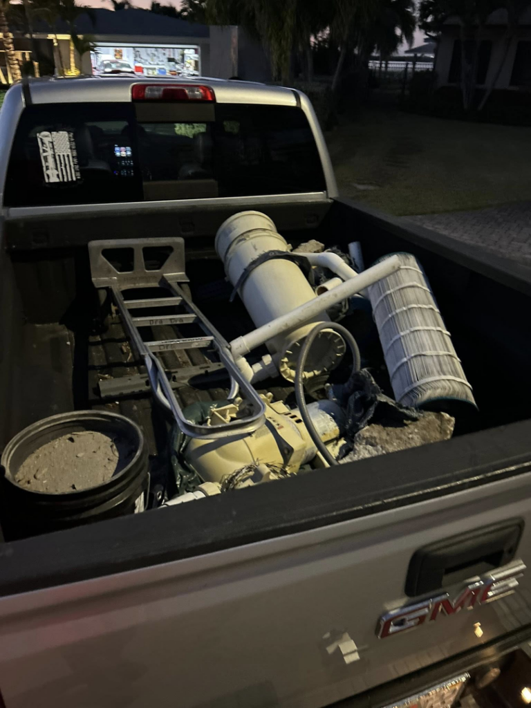 A pickup truck bed filled with old pool equipment and various junk items for removal by A1 JUNK Removal in Cocoa Beach, FL.