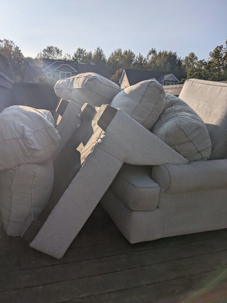 A truck bed loaded with old upholstered furniture for removal by 5 Star Junk Removal, LLC in Elyria, OH