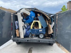 The back of a truck loaded with household junk, including children's toys and boxes, for Eastlake Hauling and Junk Removal, LLC in Chula Vista, CA.