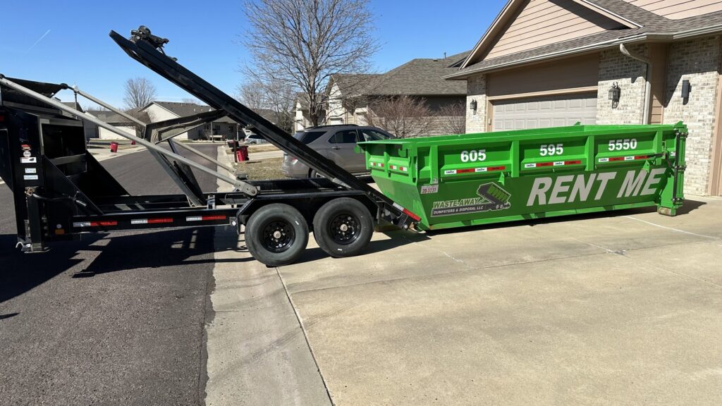 A truck deploying a green dumpster from Waste-Away Dumpsters & Disposal LLC for junk removal services in Sioux Falls, SD.