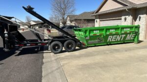 A truck deploying a green dumpster from Waste-Away Dumpsters & Disposal LLC for junk removal services in Sioux Falls, SD.