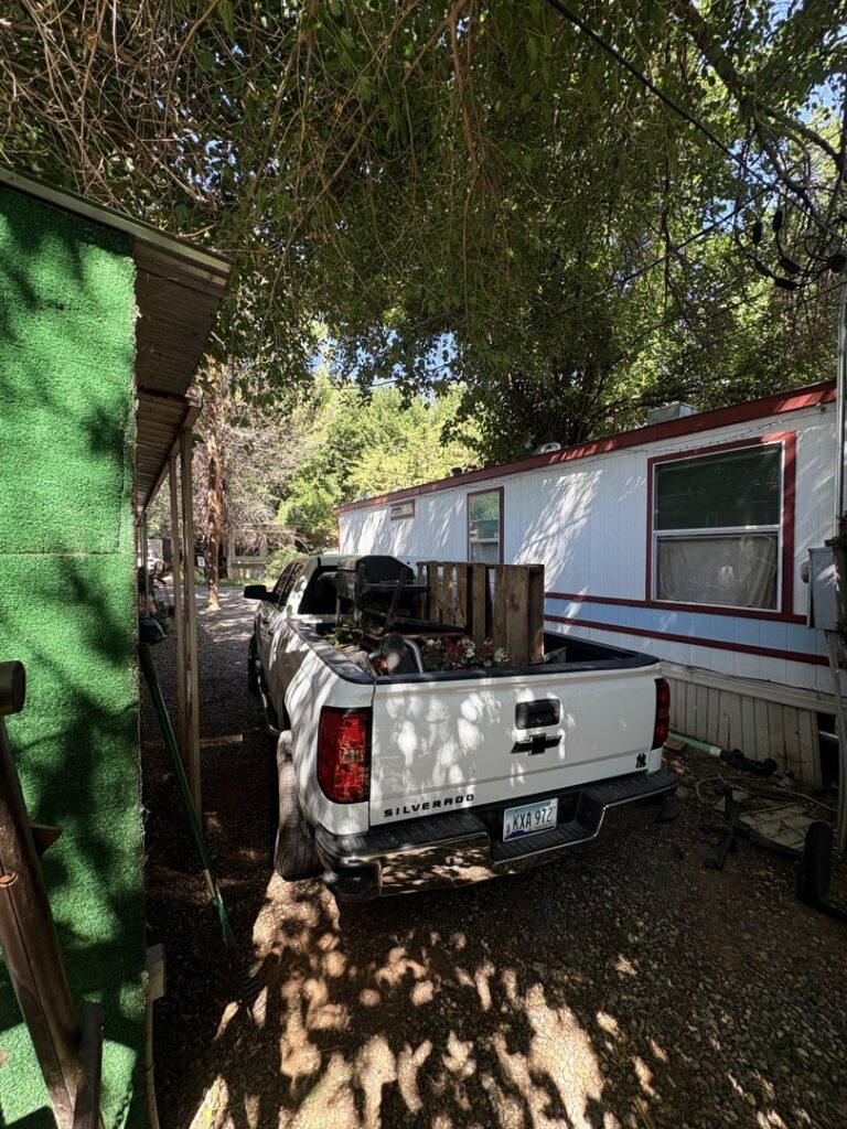 A richartehelps pickup truck hauling a grill and wood debris from a residential property in Scottsdale, AZ.