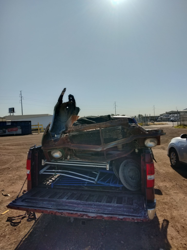 A pickup truck loaded with scrap metal and other junk, being hauled away by Harvey's Junk Hauling and Recycling LLC in Scottsdale, AZ.