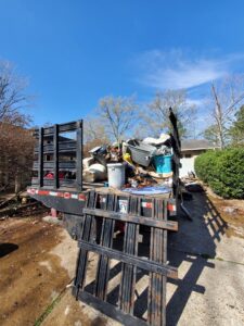 A Sonny Day Junk Removal truck loaded with various appliances and furniture for removal in Batesville, AR.