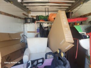 A truck loaded with various household items and junk during a removal service by Dump My Junk LLC Demolition & Dumpster Rental in Tampa, FL.