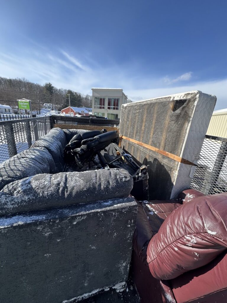 A truck bed loaded with old furniture and debris, ready for removal by K & W Materials & Recycling LLC in Springfield, MA.