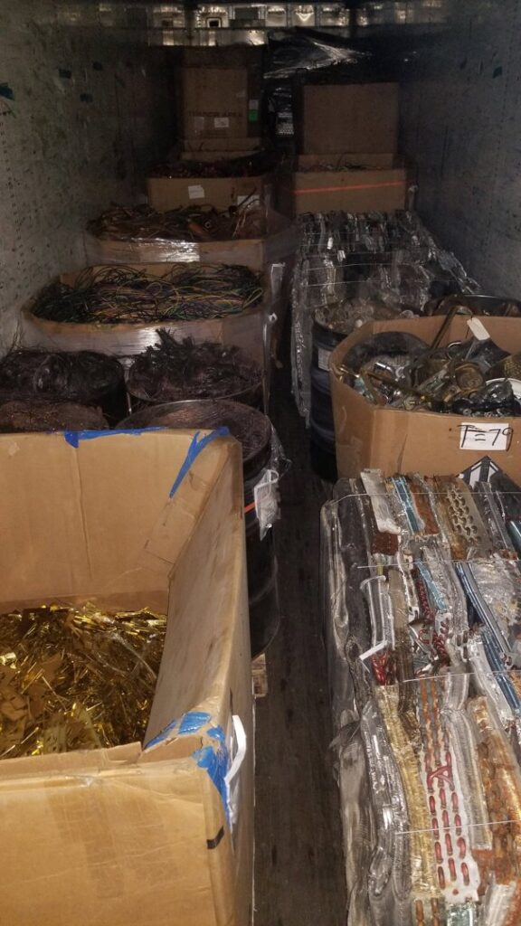 A truck interior loaded with various scrap metal and wires in boxes for recycling at Get Green Recycling Co. in Aurora, IL.