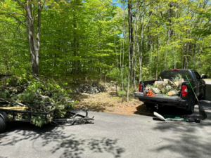 A truck and trailer loaded with tree branches and yard waste for removal by Averson Hauling & Disposal LLC in Lebanon, ME