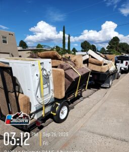 A truck and trailer loaded with old furniture and a washing machine for junk removal by Jigsaw Transport and Waste in Albuquerque, NM.