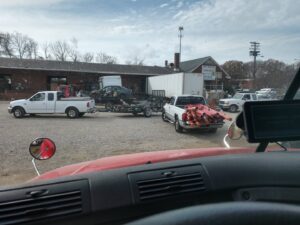 Multiple trucks and trailers bringing materials to the salvage yard at Queen City Metal Recycling & Salvage in Charlotte, NC.