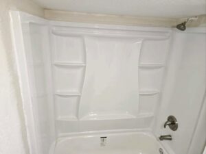 A newly installed white tub and shower surround, demonstrating bathroom renovation services by Mr. Affordable LLC in Denver, CO.