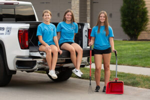Turd Terminators employees with pooper scoopers and a rake, ready for pet waste removal in Omaha, NE.