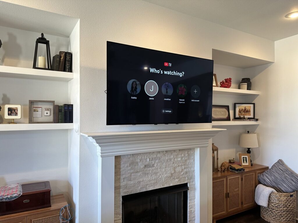 A flat-screen television professionally mounted above a fireplace by I Know A Guy Handyman Service in Cottage Grove, MN.