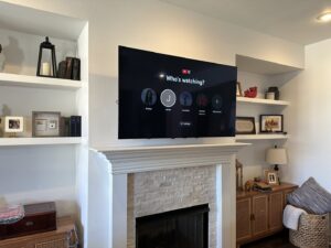 A flat-screen television professionally mounted above a fireplace by I Know A Guy Handyman Service in Cottage Grove, MN.