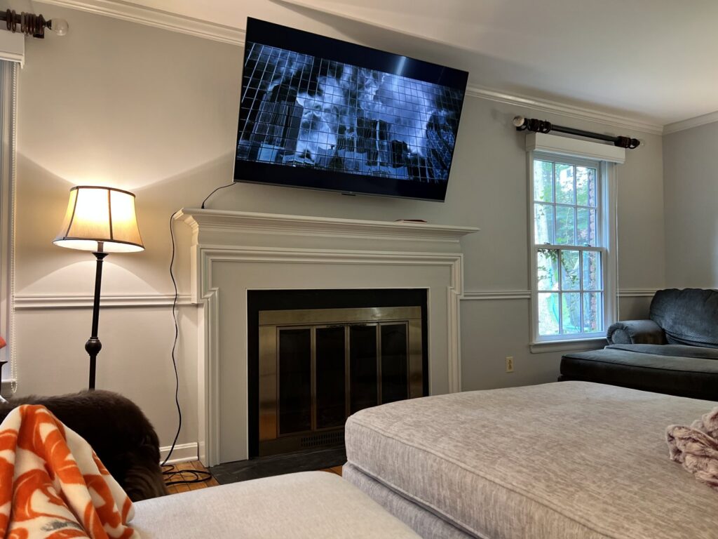 A flat-screen television professionally mounted above a fireplace in a living room by In Goode Hands LLC in Beckley, WV.