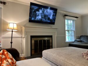 A flat-screen television professionally mounted above a fireplace in a living room by In Goode Hands LLC in Beckley, WV.