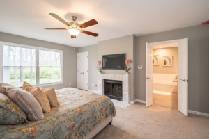 A bedroom featuring a TV professionally mounted above an updated fireplace by EMR Contracting, LLC in Linden, NJ