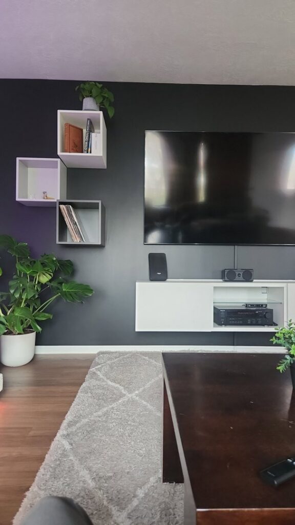 A modern living room with a wall-mounted TV and floating shelves, services provided by Branham Handyman in Salt Lake City, UT