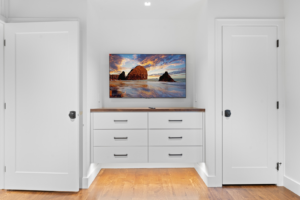 A professionally mounted television above custom built-in drawers, installed by Thimijan Custom Homes LLC in Rochester, MN