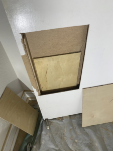 A mounted television above a stone veneer fireplace with a wooden mantel, showcasing installation work by Rock Solid Handyman Services in Sparks, NV.